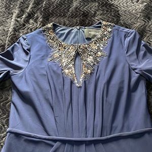 Gently used navy blue gown with beaded collar and zip closure back. Fully lined